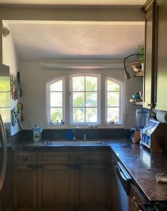Kitchen window in Santa Clara with roller shades pulled up for full outdoor view